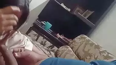 The lady gives a desi blowjob to the man on the couch